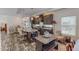 Spacious kitchen featuring a large island, dark wood cabinets, and modern lighting fixtures at 153 Bywood Dr, Roxboro, NC 27573