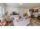 Cozy living room featuring wood floors, a comfortable sofa, and a large television at 153 Bywood Dr, Roxboro, NC 27573