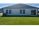 The back exterior of this home features well-maintained lawn, sliding glass door and several windows for ample natural light at 16 Vale Spring Ln, Lillington, NC 27546