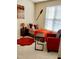 Charming bedroom with colorful decor, including an accent chair, artwork, and ample natural light at 1633 Snow Mass Way, Durham, NC 27713