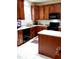 Well-equipped kitchen featuring wooden cabinetry, modern appliances, and practical layout at 1633 Snow Mass Way, Durham, NC 27713