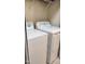Well-lit laundry area with white washer and dryer, plus convenient overhead shelving at 1633 Snow Mass Way, Durham, NC 27713