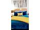 Inviting main bedroom featuring a plush bed with a bright yellow throw and decorative pillows at 1633 Snow Mass Way, Durham, NC 27713