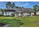 Spacious backyard with a well-maintained lawn, a deck, and mature trees create a serene outdoor living space at 169 Clearwater Harbor Hbr, Sanford, NC 27332