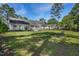 Large backyard with a garden, patio, mature trees, and blue skies at 169 Clearwater Harbor Hbr, Sanford, NC 27332