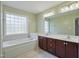Bathroom featuring a soaking tub, double sink vanity, and a window at 169 Clearwater Harbor Hbr, Sanford, NC 27332