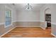 Bright dining room with wood floors and an elegant chandelier that hangs over the room at 169 Clearwater Harbor Hbr, Sanford, NC 27332