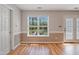 Bright dining room features wood floors, large window, and glass patio doors at 169 Clearwater Harbor Hbr, Sanford, NC 27332