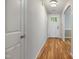 Bright hallway with light wood floors leading to the front door with decorative glass at 169 Clearwater Harbor Hbr, Sanford, NC 27332