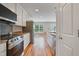 Modern eat-in kitchen featuring stainless steel appliances, bright countertops, and wood-style floors at 169 Clearwater Harbor Hbr, Sanford, NC 27332
