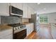 Close up of the kitchen's stove, with granite countertops and stainless steel appliances at 169 Clearwater Harbor Hbr, Sanford, NC 27332