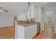 Kitchen island with stainless steel sink, light countertops and white cabinets at 169 Clearwater Harbor Hbr, Sanford, NC 27332