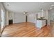 Open-concept living space with wood flooring, fireplace, and kitchen area at 169 Clearwater Harbor Hbr, Sanford, NC 27332