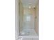 Modern shower with glass door, neutral tile, and built-in shelving niche at 169 Clearwater Harbor Hbr, Sanford, NC 27332