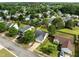 Aerial view of the home showing surrounding houses and greenery at 1728 E Honey Springs Ave, Fuquay Varina, NC 27526