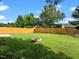 Home featuring a large backyard, privacy fence and a fire pit at 1728 E Honey Springs Ave, Fuquay Varina, NC 27526
