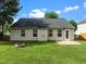 Backyard featuring green lawn, patio, fire pit and partial fence surround at 1728 E Honey Springs Ave, Fuquay Varina, NC 27526