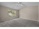 Spacious bedroom with large window and neutral carpet at 1728 E Honey Springs Ave, Fuquay Varina, NC 27526