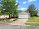Pleasant one-story home with a two-car garage, a well-kept lawn and a mature shade tree at 1728 E Honey Springs Ave, Fuquay Varina, NC 27526