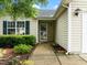 Welcoming front entrance with a well-maintained walkway and manicured garden at 1728 E Honey Springs Ave, Fuquay Varina, NC 27526