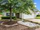 Charming one-story home with a two-car garage, lush landscaping, and a mature tree at 1728 E Honey Springs Ave, Fuquay Varina, NC 27526