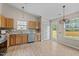 Bright kitchen with stainless steel appliances, granite countertops, and light wood cabinets at 1728 E Honey Springs Ave, Fuquay Varina, NC 27526