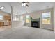 Bright living room featuring a cozy fireplace and neutral carpet with open view to kitchen at 1728 E Honey Springs Ave, Fuquay Varina, NC 27526
