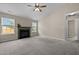 Spacious living room featuring a fireplace, ceiling fan, and ample natural light at 1728 E Honey Springs Ave, Fuquay Varina, NC 27526
