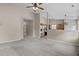 Spacious living room with neutral carpet and an open view into the kitchen at 1728 E Honey Springs Ave, Fuquay Varina, NC 27526