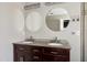 Elegant bathroom featuring double vanities with granite countertop and modern fixtures at 18 Gwendolyn Cir, Durham, NC 27703