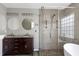 Beautiful bathroom featuring double vanities, glass-enclosed shower and soaking tub at 18 Gwendolyn Cir, Durham, NC 27703