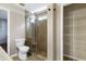 Bathroom featuring a glass shower, toilet, and doorway into a closet at 18 Gwendolyn Cir, Durham, NC 27703