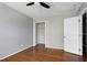 Well-lit bedroom with wood floors, ceiling fan, and open closet for easy access at 18 Gwendolyn Cir, Durham, NC 27703