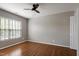 Inviting bedroom with hardwood floors, large window, and ceiling fan with light at 18 Gwendolyn Cir, Durham, NC 27703