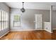 Bright dining area featuring hardwood floors, neutral paint, and a modern chandelier at 18 Gwendolyn Cir, Durham, NC 27703