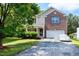 Charming two-story home featuring a brick facade, a covered front porch, and a well-maintained lawn at 18 Gwendolyn Cir, Durham, NC 27703