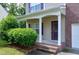 Inviting covered porch with white columns, brick steps, and manicured landscaping for enhanced curb appeal at 18 Gwendolyn Cir, Durham, NC 27703