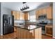 Modern kitchen with stainless steel appliances, granite countertops, center island, and wooden cabinets at 18 Gwendolyn Cir, Durham, NC 27703
