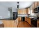 Spacious kitchen with stainless steel appliances, granite countertops, center island, and wooden cabinets at 18 Gwendolyn Cir, Durham, NC 27703