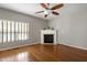 Comfortable living room featuring a fireplace, ceiling fan and hardwood floors at 18 Gwendolyn Cir, Durham, NC 27703