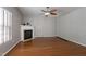 Cozy living room with a fireplace, hardwood floors, and lots of natural light at 18 Gwendolyn Cir, Durham, NC 27703