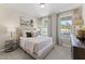 Cozy bedroom with neutral tones, elegant curtains, and a view of the outdoors at 2006 Kapalua Way # 190, Durham, NC 27703