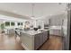 Open concept kitchen with stainless steel appliances, island with sink, and modern lighting at 2006 Kapalua Way # 190, Durham, NC 27703