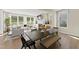 Bright living area with dining table, cozy fireplace, large windows, and comfortable seating at 2006 Kapalua Way # 190, Durham, NC 27703