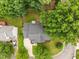 Aerial view of the house showcasing the roof, driveway, landscaping, and surrounding trees at 205 Town Creek Dr, Cary, NC 27519