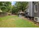 Backyard featuring a patio with outdoor seating, and a well-maintained lawn at 205 Town Creek Dr, Cary, NC 27519