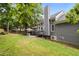 Landscaped backyard showcasing a patio with outdoor furniture, and lush lawn at 205 Town Creek Dr, Cary, NC 27519