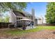 Exterior of the home showcasing backyard with patio, furniture, and lush lawn at 205 Town Creek Dr, Cary, NC 27519
