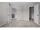 Neutral bedroom with carpeted floors, featuring two open doorways at 205 Town Creek Dr, Cary, NC 27519