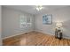 Simple bedroom features hardwood floors, window with blinds, and neutral walls at 205 Town Creek Dr, Cary, NC 27519